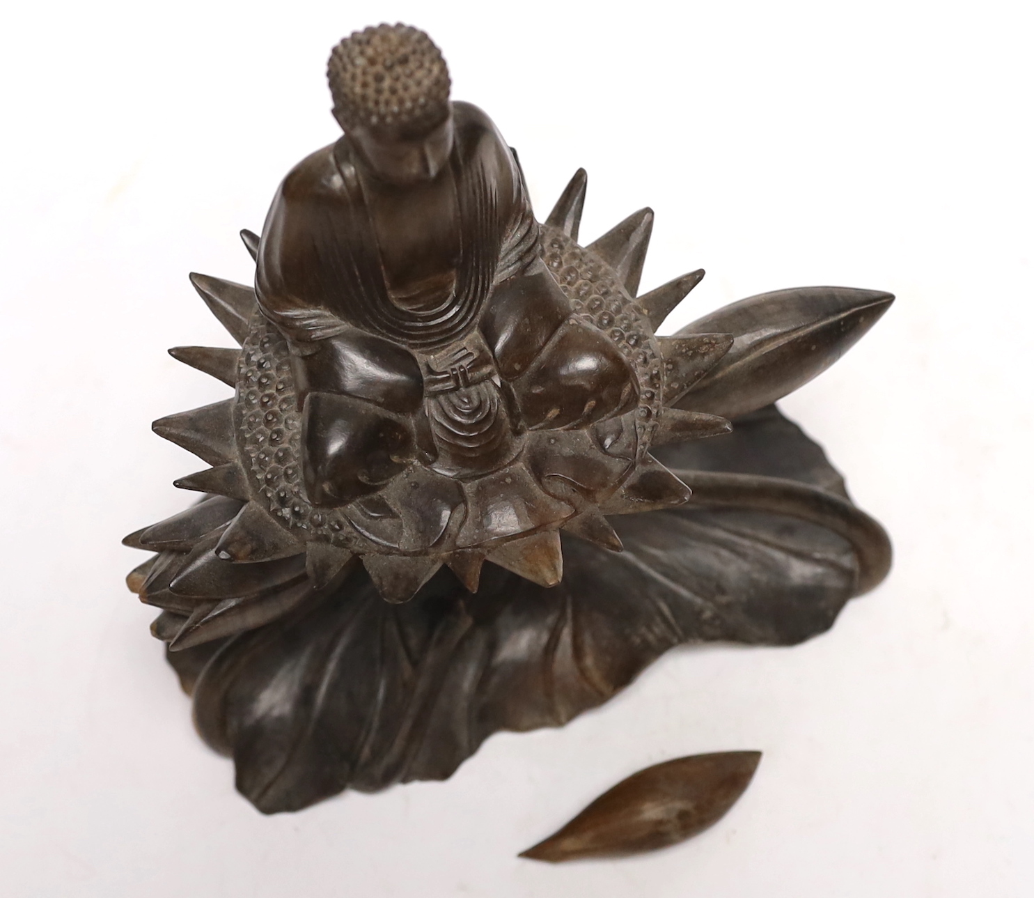 A Thai carved hardwood model of a Buddha on a lotus, damaged, loose piece, 22cm